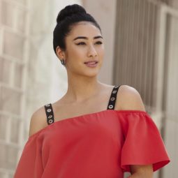 woman with dark brown hair with a basic hair bun hairstyles