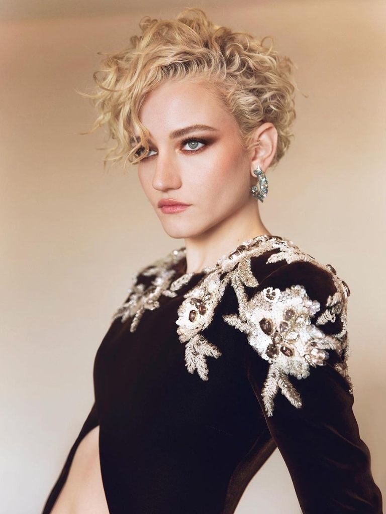 Julia Garner with curly blonde hair