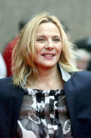 Kim Cattrall with lob hairstyle in grey and black suit