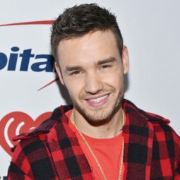 one direction singer liam payne wearing a red checked shirt with his signature cropped hairstyle