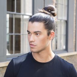 Man bun tutorial brunette man looking away from camera in street