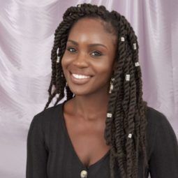 Braid hairstyles Photo of a woman with long twisted marley braids with hair cuffs, wearing a black top