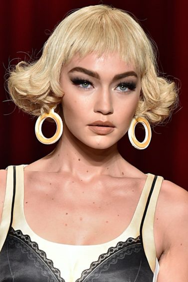 gigi hadid with a blonde curly bob on the moschino ss17 runway