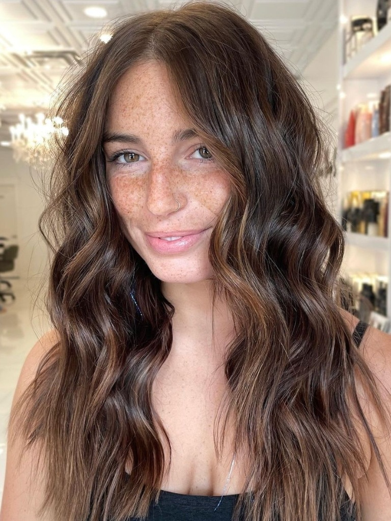 Woman with dark brown hair and balayage