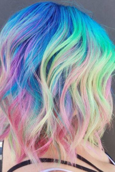 Neon rainbow hair - long bob length wavy rainbow colour hair side view