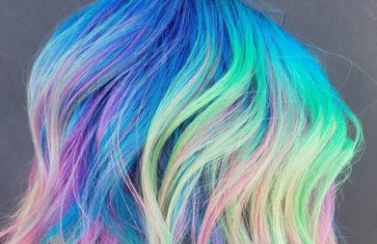 Neon rainbow hair - long bob length wavy rainbow colour hair side view