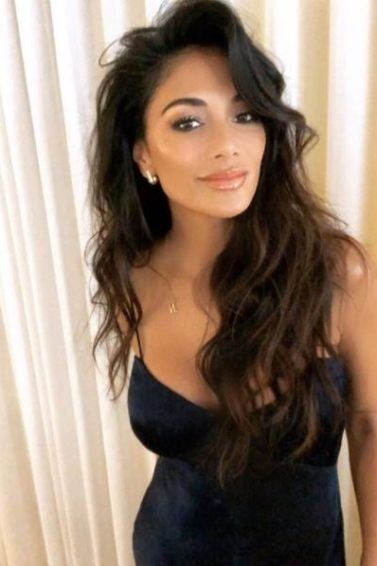 front view of nicole scherzinger with long dark hair with voluminous waves