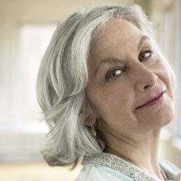 An older lady with grey short layered hair