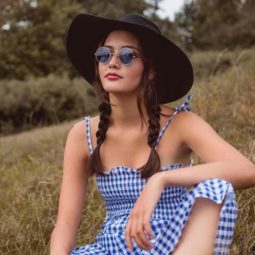 brown medium length hair in pigtail braids with wide brim hat