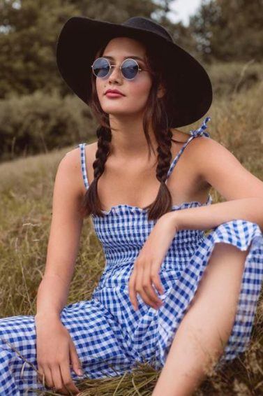 brown medium length hair in pigtail braids with wide brim hat