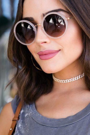 medium bob hairstyles: olivia culpo with short wavy bob hairstyle wearing sunglasses and smiling