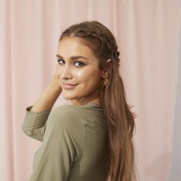 Woman touching her healthy long brown hair