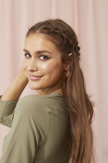 Woman touching her healthy long brown hair