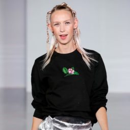 Ideas for crazy hair day: Blonde runway model with her hair in tiny random braids, wearing a black sweatshirt and silver skirt