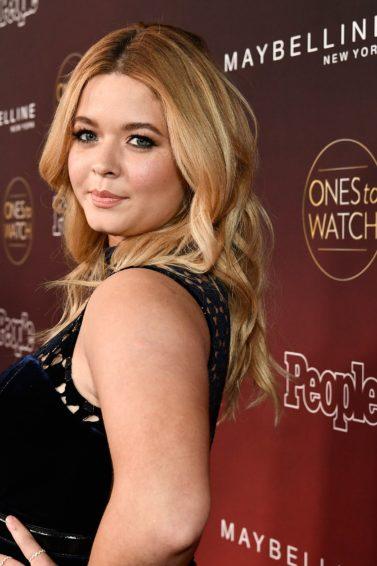 close up shot of sasha pieterse at the people's ones to watch party, wearing black dress and curly hair