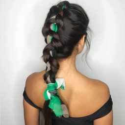 Dutch Braid Hairstyles: Woman with long dark brunette hair in a single large Dutch braid with a green print scarf woven through