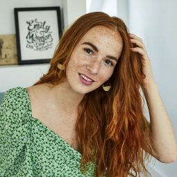 Woman touching her long red wavy hair