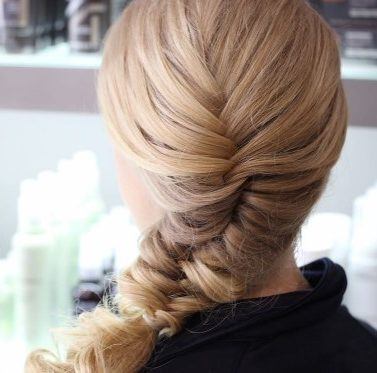 blonde woman with a side fishtail braid hairstyle