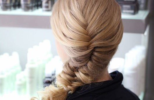 blonde woman with a side fishtail braid hairstyle