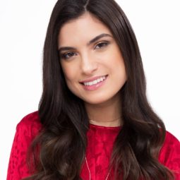 brunette woman wearing red with blowout style sock curls