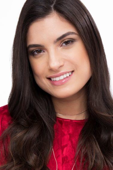 brunette woman wearing red with blowout style sock curls