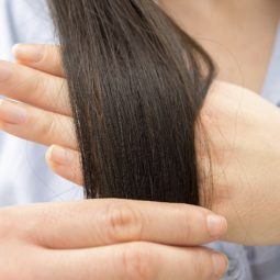 Split end treatment All Things Hair - IMAGE - brown long hair being examined