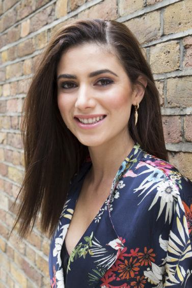 how to straighten hair without heat: model outside smiling wearing floral outfit