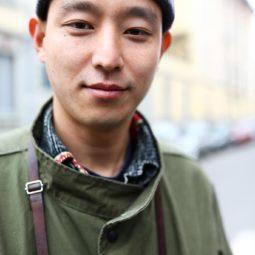 Asian men hairstyles: A young Asian man wearing a ribbed beanie hat