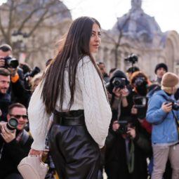 Brunette woman with long thick hair at fashion week