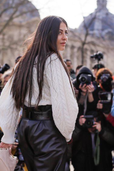 Brunette woman with long thick hair at fashion week