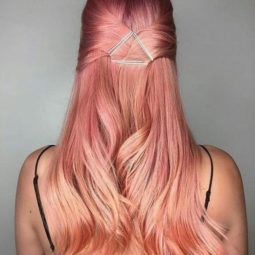 Sushi hair - long pastel peach pink hair worn in a half-up hairstyle with a geo hair accessory