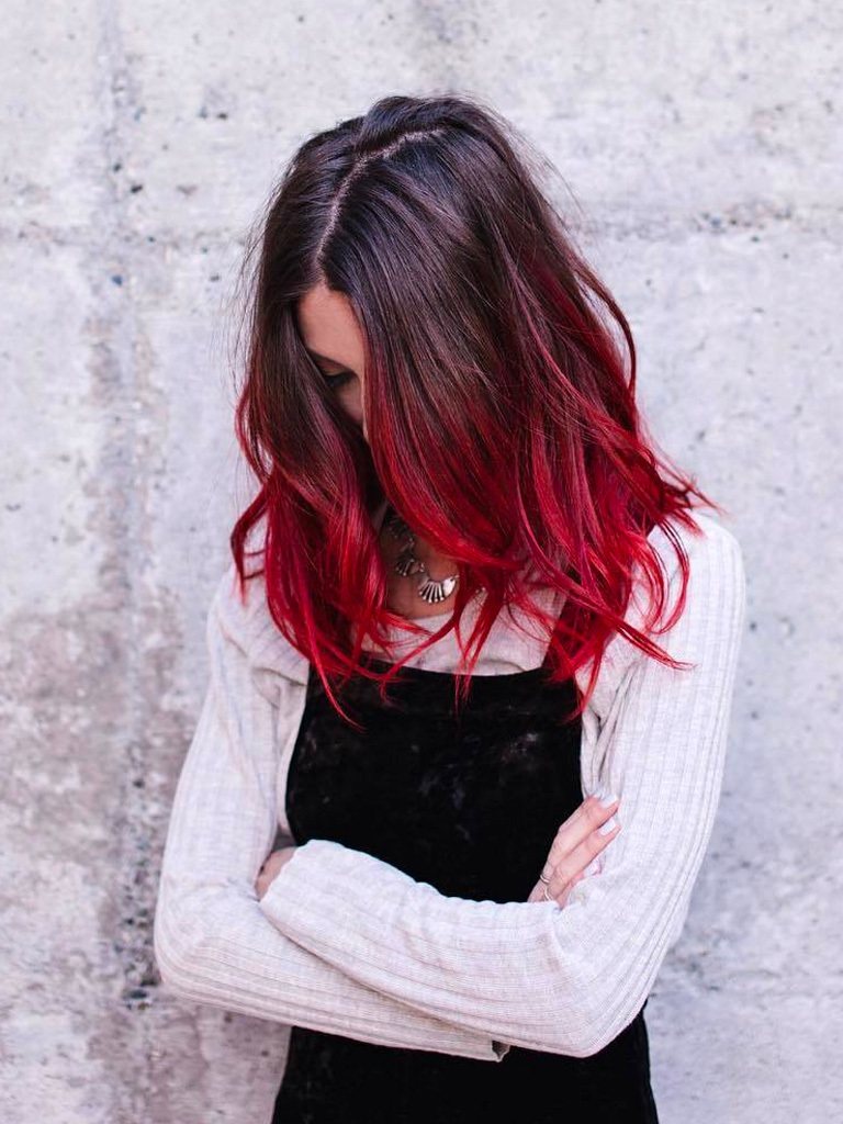 Woman with dark brown to cherry red colour melt posing outside