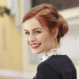 Happy redhead with twist updo hairstyle