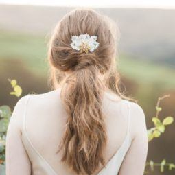 back shot of a brunette woman with her hair in a twisted low ponytail