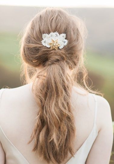 back shot of a brunette woman with her hair in a twisted low ponytail