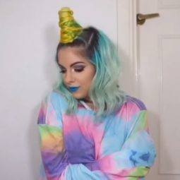 Unicorn hair: Blogger Sophie Hannah Richardson with multicoloured unicorn hair with a yellow unicorn horn, wearing a tie dye rainbow sweatshirt