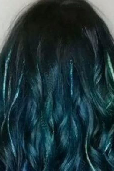 back view of emerald green wavy long hair with glitter highlights