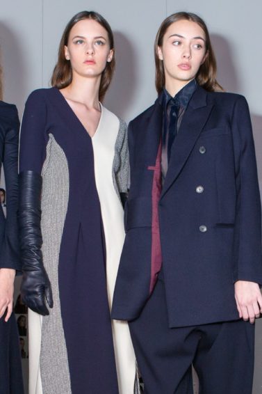 group of models with straight natural looking hair backstage of fashion show