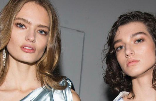 what is hair mousse: shot of two models with voluminous hair, backstage posing