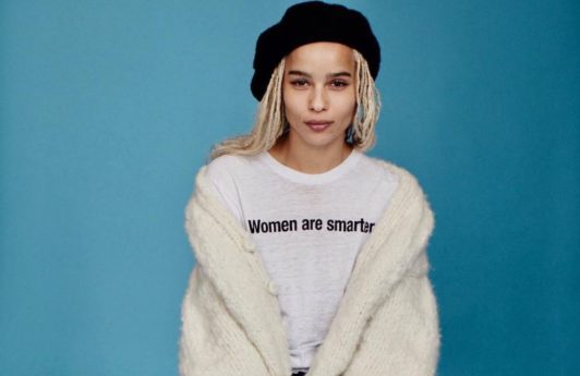 Zoe Kravitz sat on a stool wearing a black beret over her blonde box braids