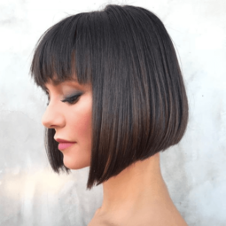 side view image of a woman with short dark hair and bangs - short hairstyles 2017