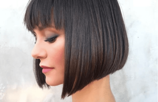 side view image of a woman with short dark hair and bangs - short hairstyles 2017